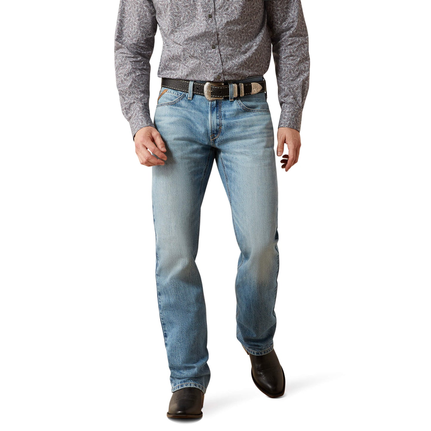 Men's light wash bootcut jeans with belt, paisley shirt, and cowboy boots