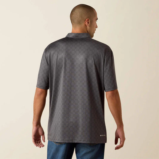Man wearing a dark gray patterned shirt on a beige background
