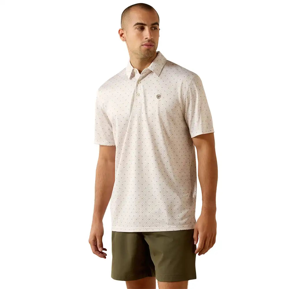 Man wearing a white short sleeve polo shirt with subtle pattern and olive green shorts