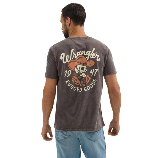 Man wearing washed black graphic t-shirt with cowboy skull print and blue jeans