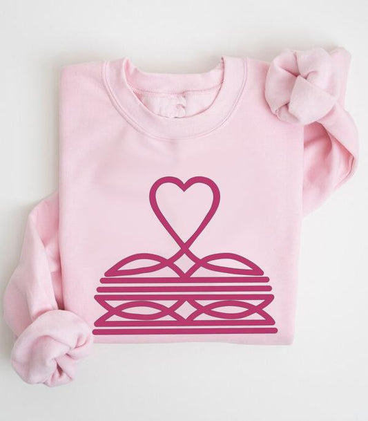 Light pink sweatshirt with magenta heart and geometric graphic design, folded neatly