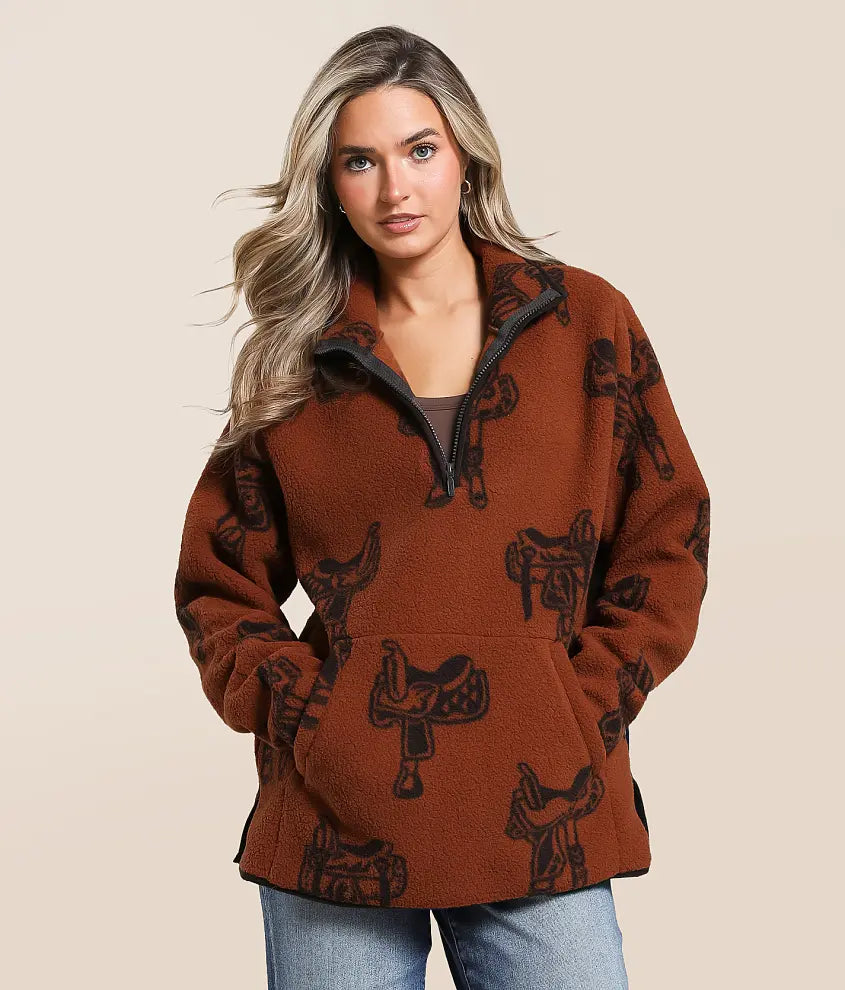 Woman wearing brown fleece pullover with black saddle print, Western casual outerwear