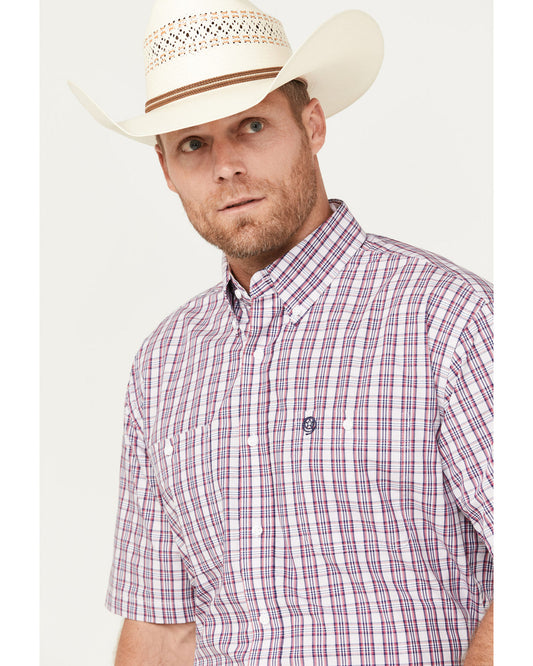 Man in white cowboy hat and plaid short sleeve western shirt