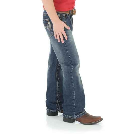 Side view of person wearing bootcut blue jeans, brown leather belt, and cowboy boots