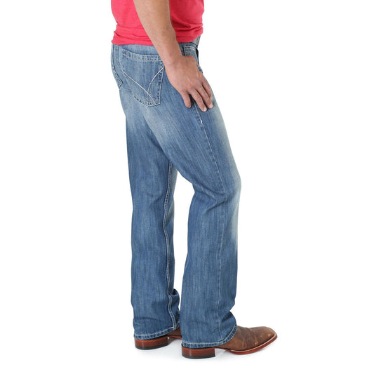 Men's light blue relaxed fit jeans with western stitching, worn with brown boots