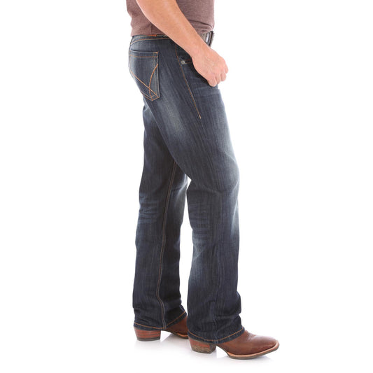 Men's dark wash bootcut jeans with contrast stitching, worn with brown boots