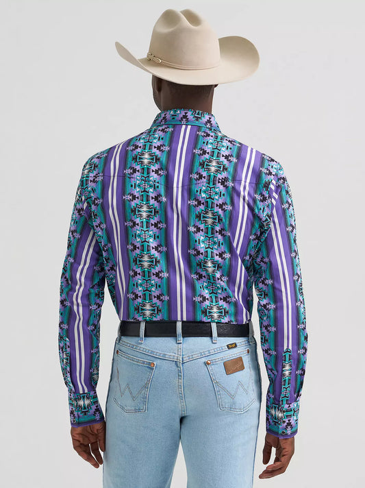 Man in cowboy hat wearing a purple patterned western shirt and light blue jeans, rear view