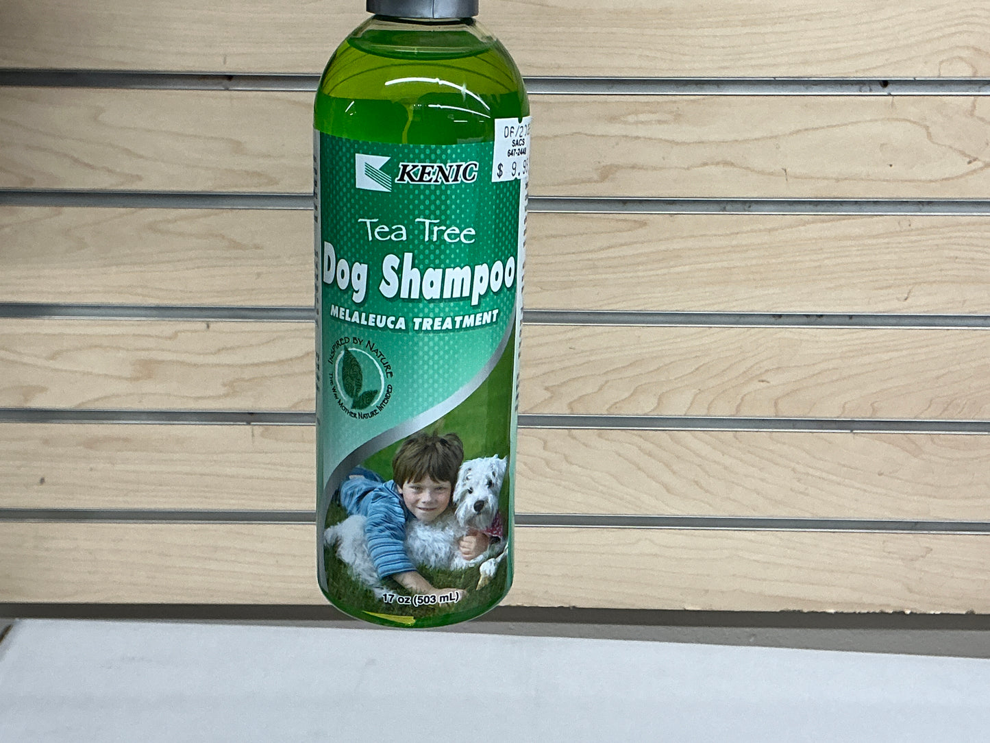 Kenic tea tree dog shampoo bottle with green label on wooden shelf, 17oz size