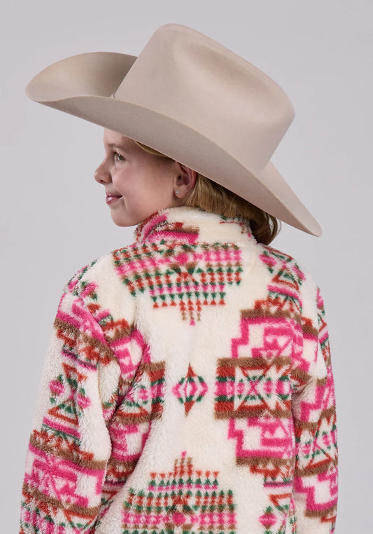Girl in beige cowboy hat and fleece jacket with pink and brown geometric pattern
