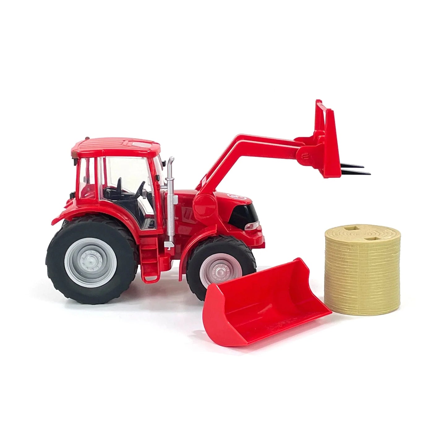 Red toy tractor with front loader, hay bale, and detachable scoop on white background