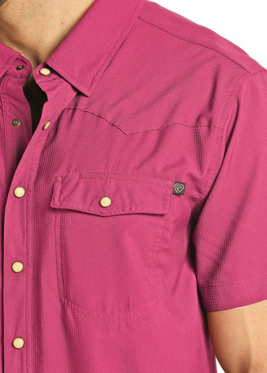 Close-up of a magenta shirt with button details on a white background