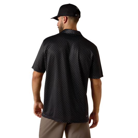 Man wearing a black patterned shirt and cap on a white background