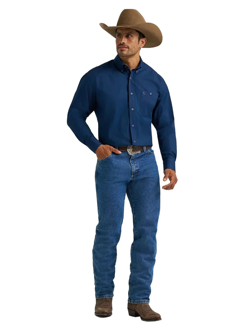 Man in cowboy hat, navy western shirt, blue jeans, and brown boots on white background