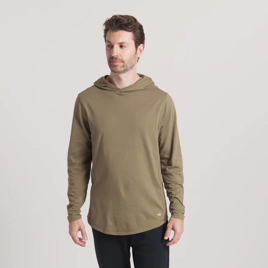 Man wearing olive green long sleeve hooded shirt, casual outfit, plain background