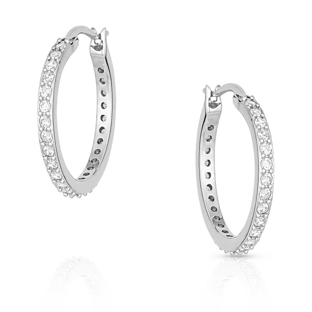 Silver hoop earrings with clear gemstones on a white background