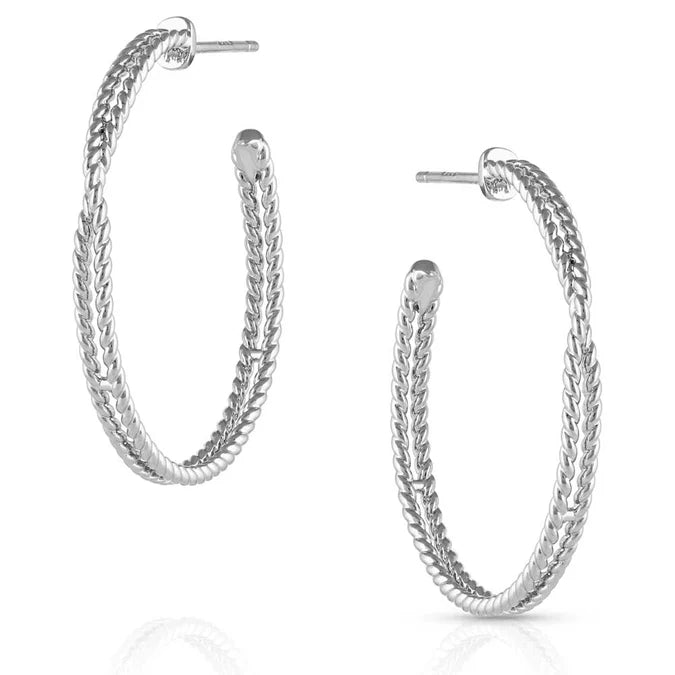 Silver twisted rope hoop earrings with textured detail on a white background