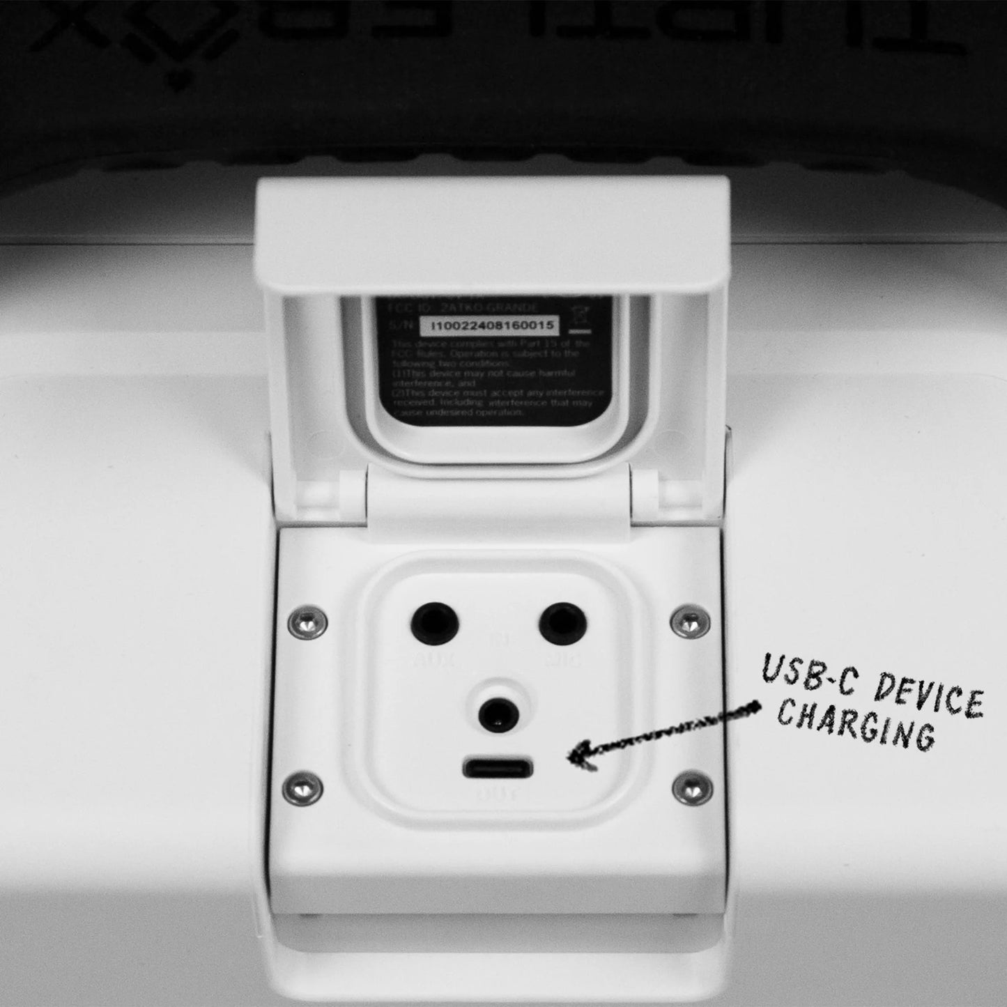 White wall socket with USB-C charging port labeled on a gray background