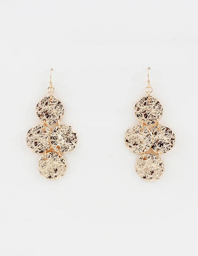 Gold dangle earrings with textured round discs on a white background
