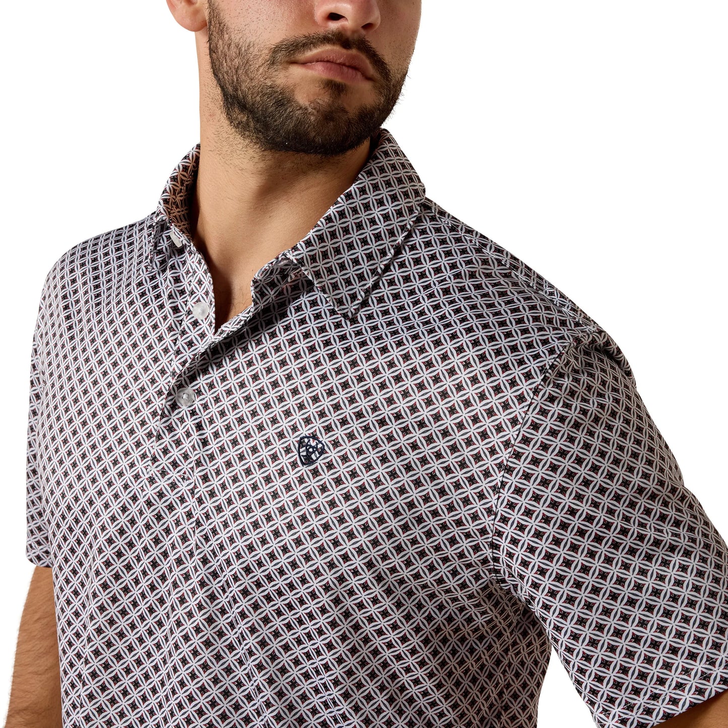 Man wearing a patterned short-sleeve shirt on a white background