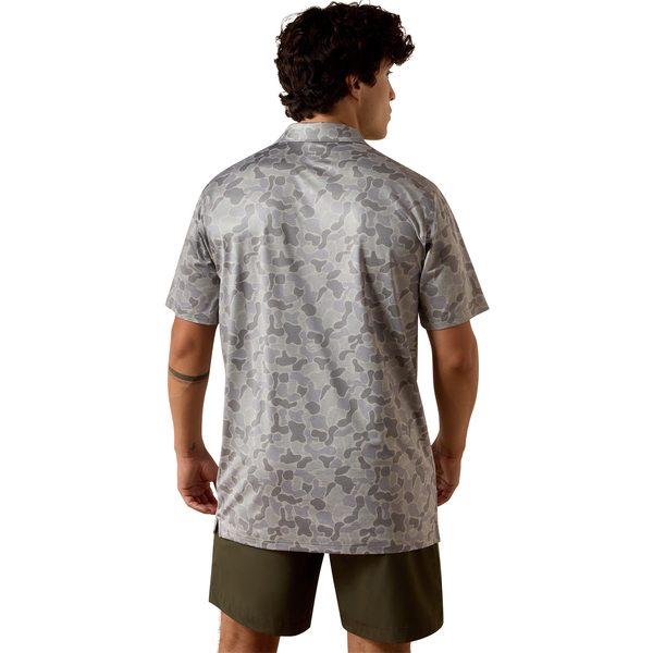 Man wearing a gray camouflage shirt and green shorts on a white background