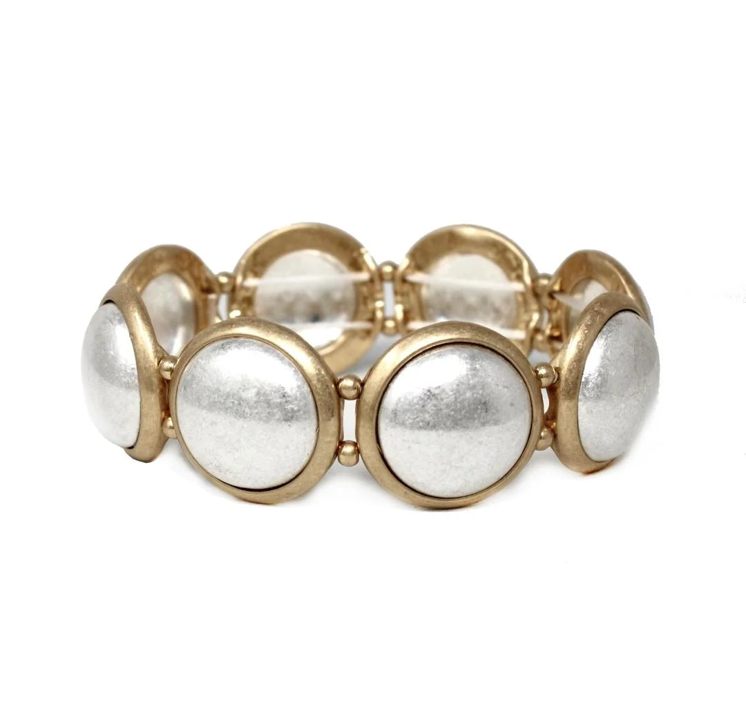 Bracelet with gold and silver circular beads on a white background