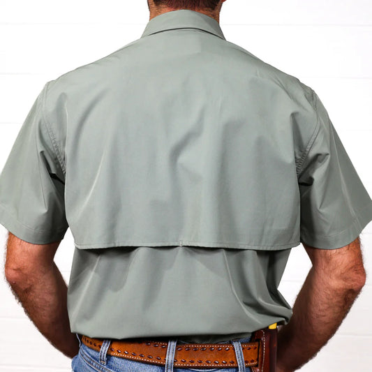 Man wearing a light gray short-sleeve shirt on a white background