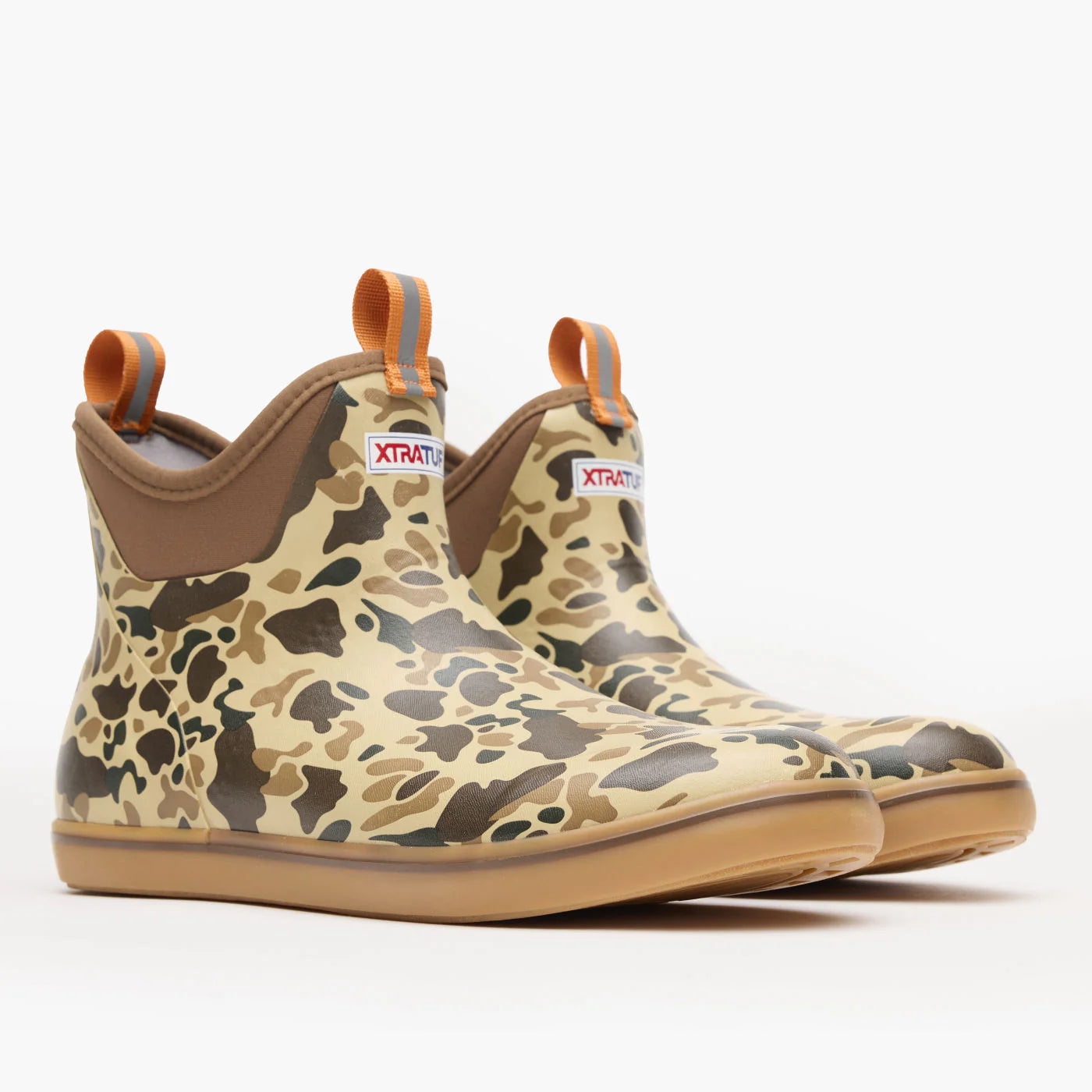 Pair of camo print waterproof ankle boots with pull tabs and tan soles