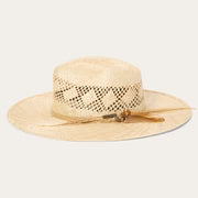 Wide brim natural straw hat with woven crown and chin strap on light background