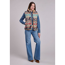 Woman wearing Aztec woven faux sherpa-lined zip vest over denim shirt and jeans