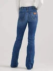 Woman wearing blue bootcut jeans with brown patch, viewed from the back
