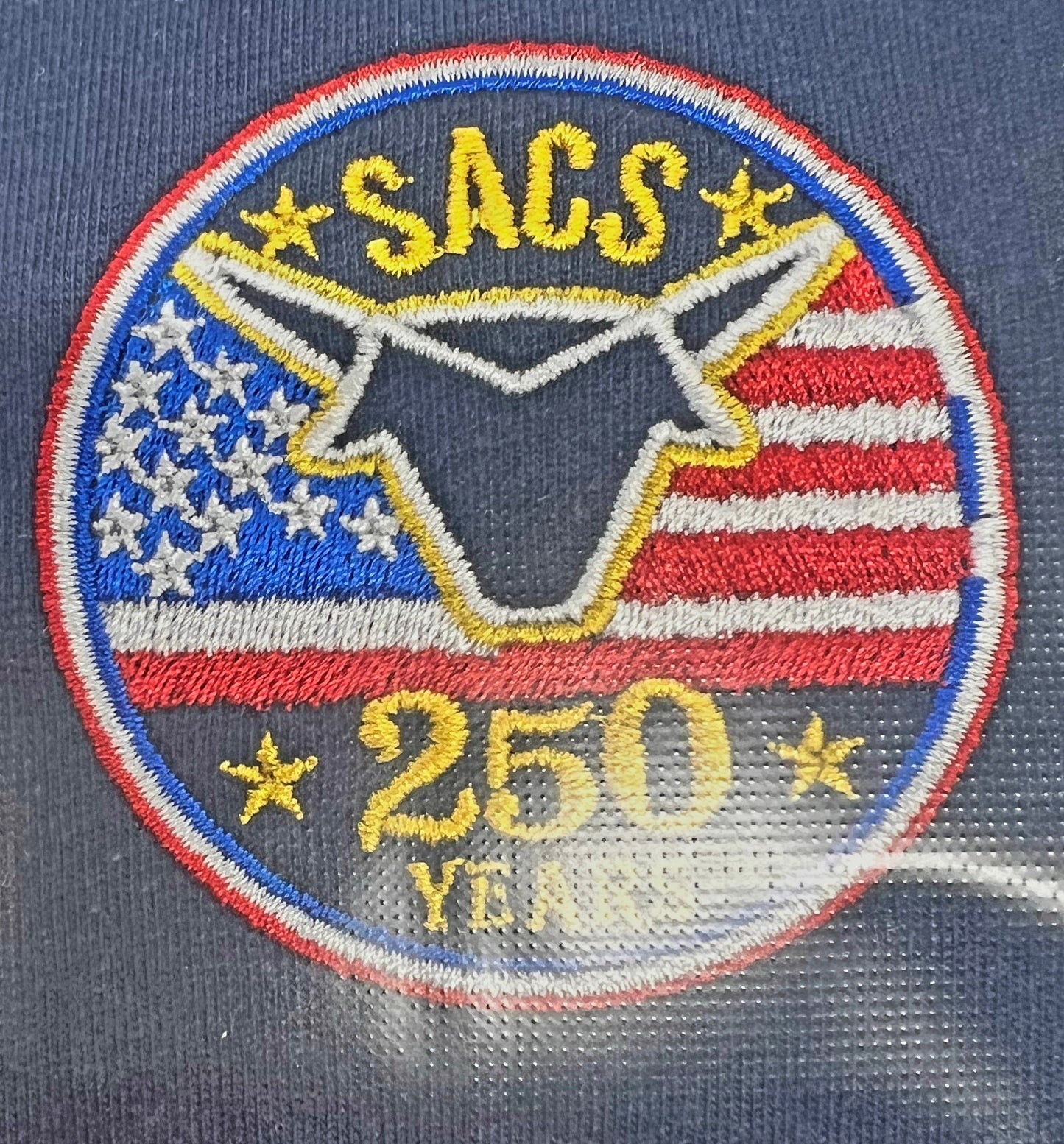 Embroidered patch with 'SACS' and '250 Years' on a blue background