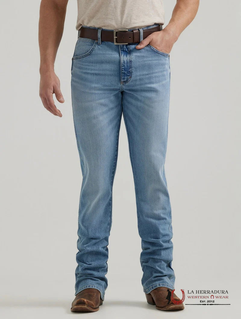 Person wearing light blue jeans with a plain background