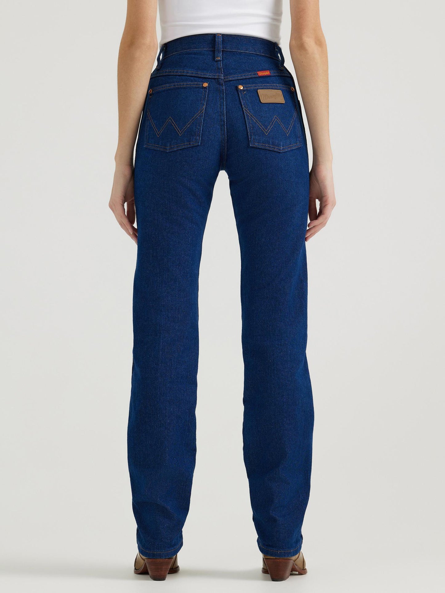 Person wearing blue jeans on a white background