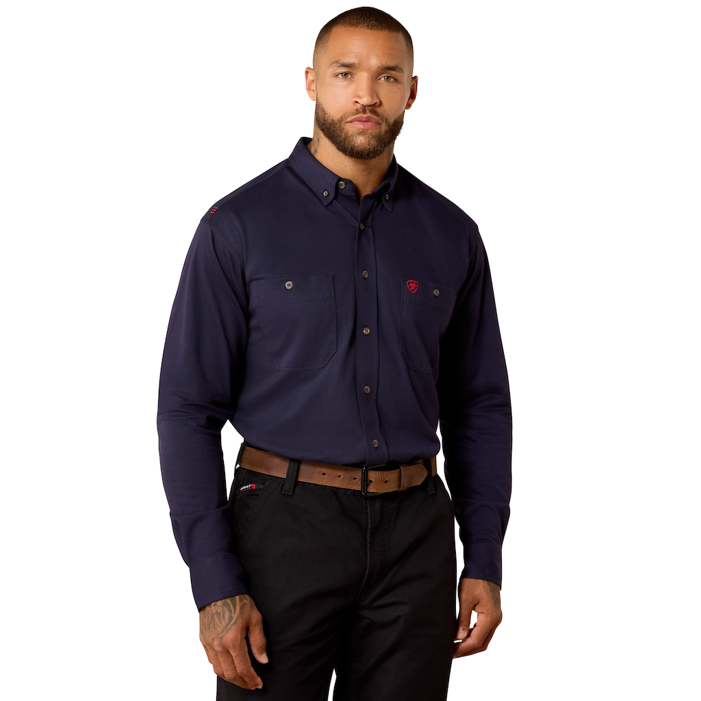Man wearing navy blue long sleeve work shirt with buttoned chest pockets and black pants