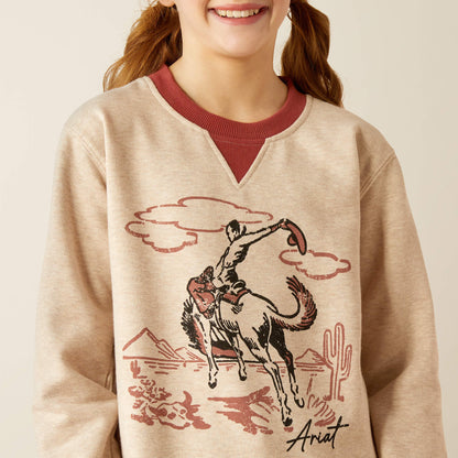 Girl wearing beige cowboy graphic sweatshirt with desert and horse illustration