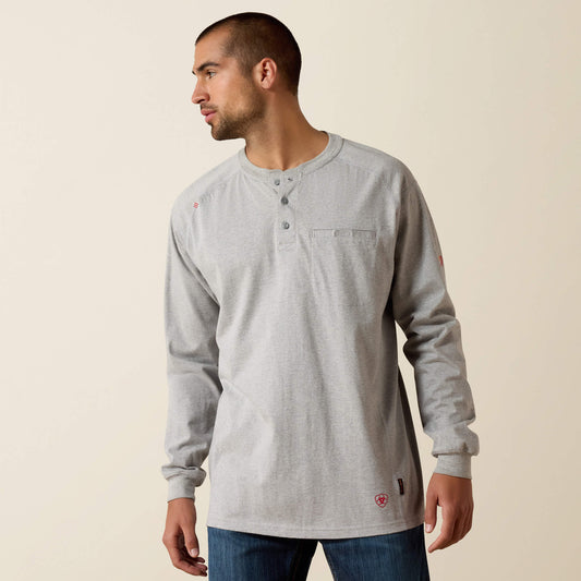 Man wearing a gray long-sleeve shirt with a brand logo on a beige background