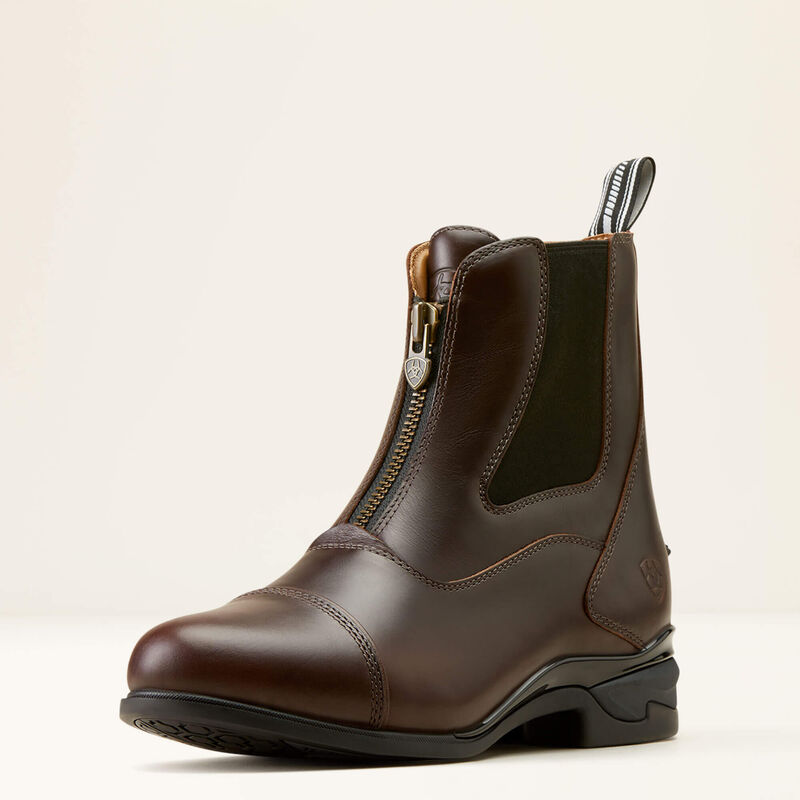 Brown leather zip-up ankle riding boot with black elastic panel and pull tab on a light background