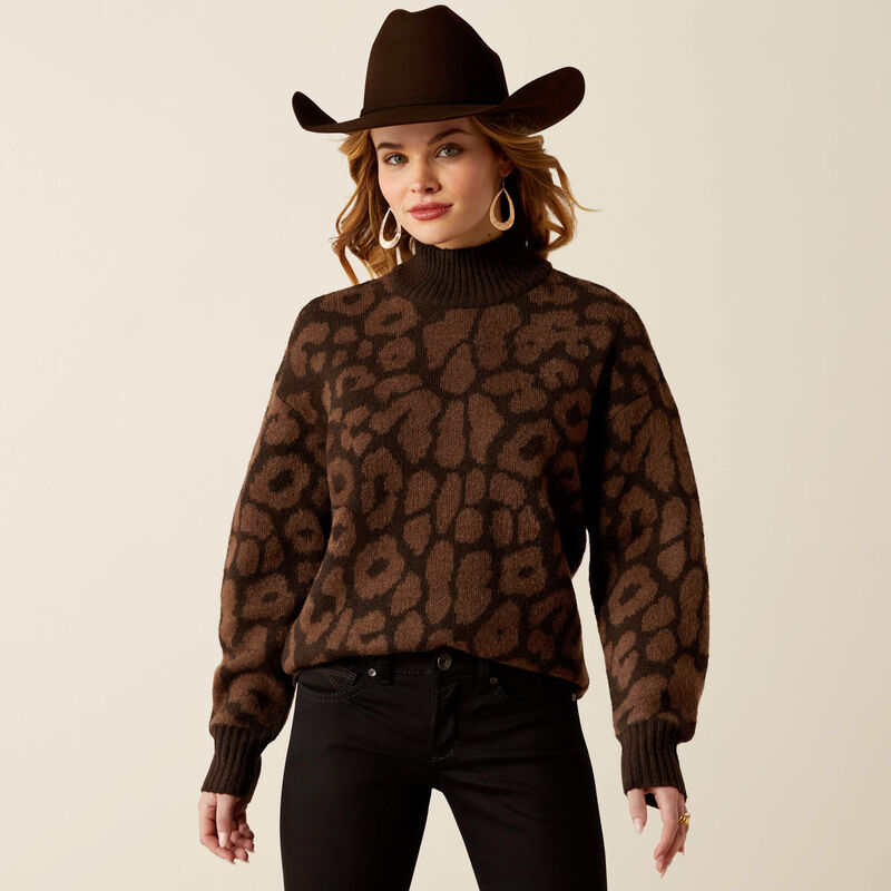 Woman wearing a brown leopard print sweater and cowboy hat on a beige background