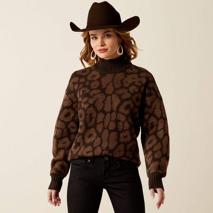 Woman wearing a brown leopard print sweater and cowboy hat on a beige background