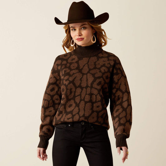 Woman wearing a brown leopard print sweater and cowboy hat on a beige background
