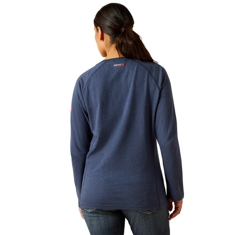 Person wearing a navy long-sleeve shirt with a brand logo on the back, standing against a white background.