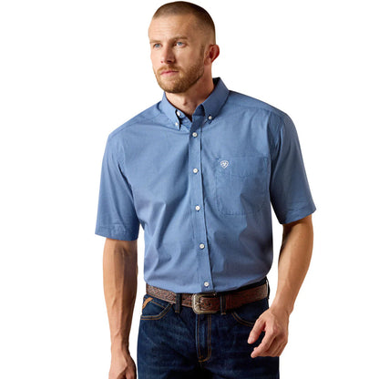 Man wearing a blue patterned short-sleeve shirt on a white background