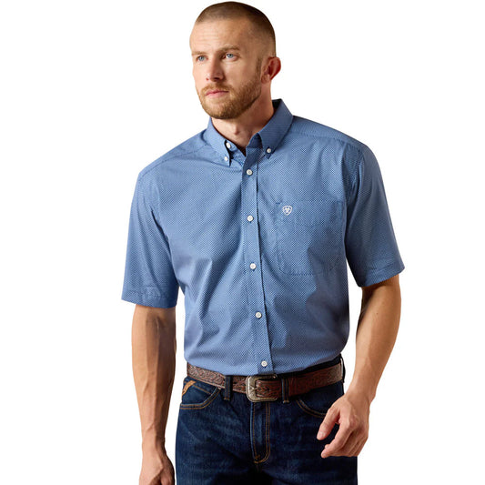 Man wearing a blue patterned short-sleeve shirt on a white background