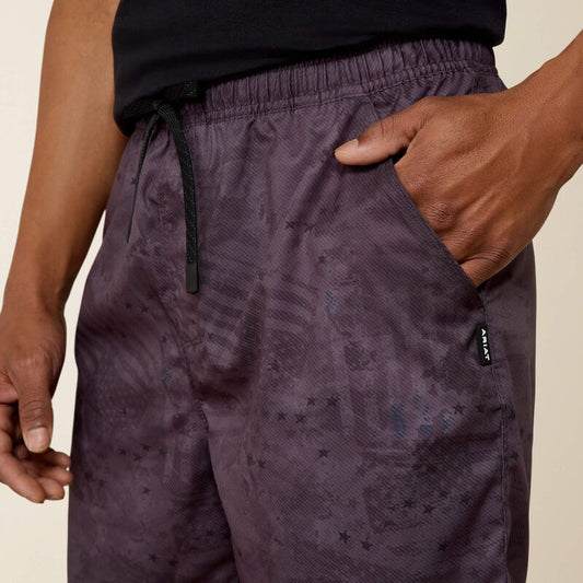 man wearing grey shorts with print on white background