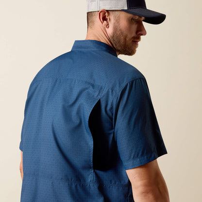 Man wearing a blue shirt and cap on a beige background