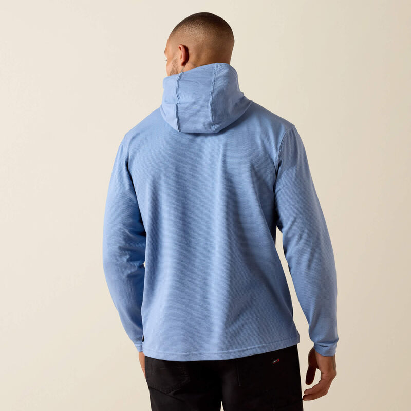 Person wearing a light blue hoodie on a beige background