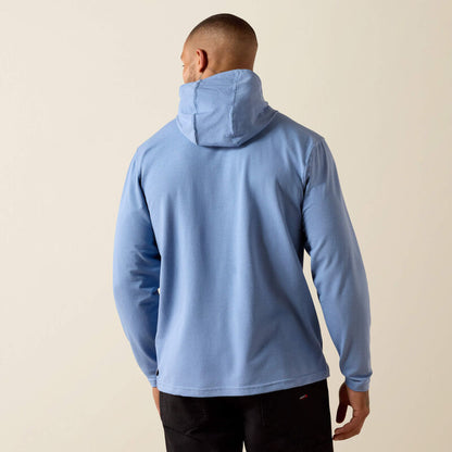 Person wearing a light blue hoodie on a beige background