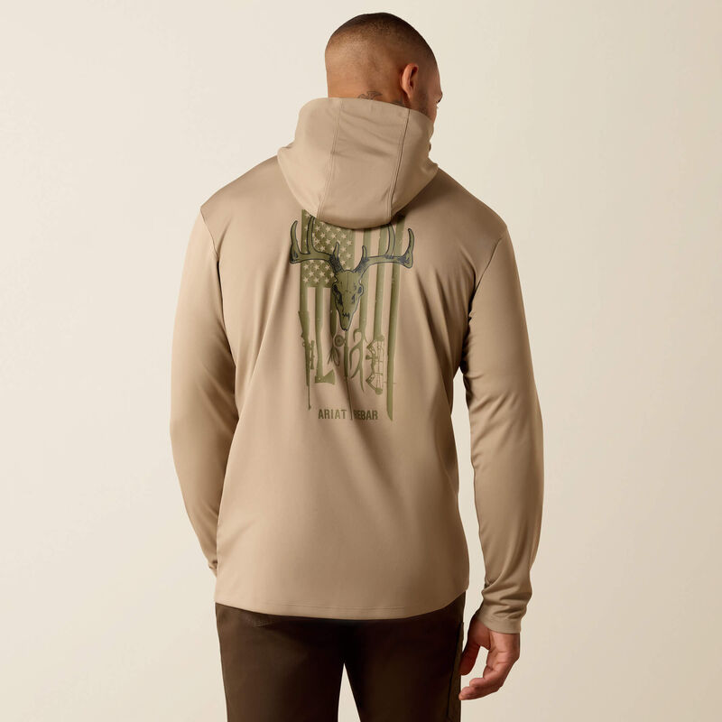 Man wearing a beige hoodie with a graphic design on the back against a beige background
