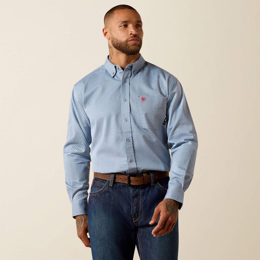 Man wearing light blue patterned button-down shirt with chest pocket, brown belt, and blue jeans