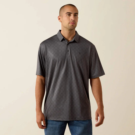 Man wearing a gray patterned polo shirt against a beige background